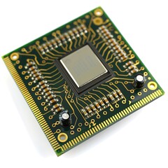 A computer chip is shown in a close up isolated on white background