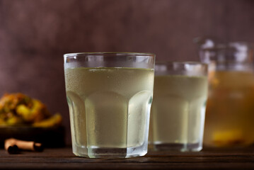 Pineapple kvass Tepache in a glasses on a wooden table. Fermented, probiotic drink.