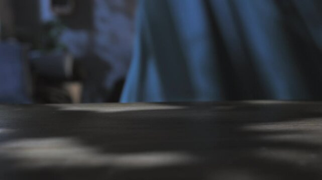 female hand picking up smart phone mobile on the table at night,woman picks up smartphone from the desk in the dark room
