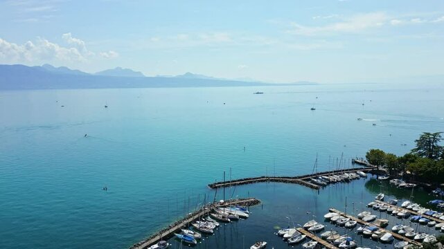 Drone push in above the Lake of Geneva and the Port of Lutry in Vaud, Switzerland