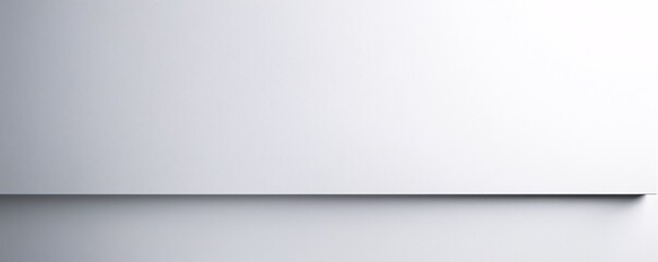 A minimalistic background featuring a smooth, seamless gradient from light grey to dark grey, creating a sophisticated and neutral canvas with plenty of copy space.