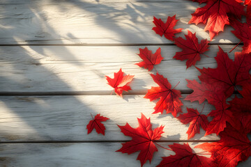 Autumn scene with red maple leaves on rustic wooden table bathed in warm sunlight