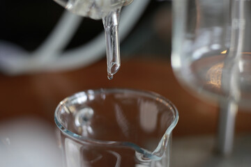 Selective Focus Drops of clear water on a glass tube to test the distillation of alcoholic beverages. Try testing a drop of very clear water to see how it works.