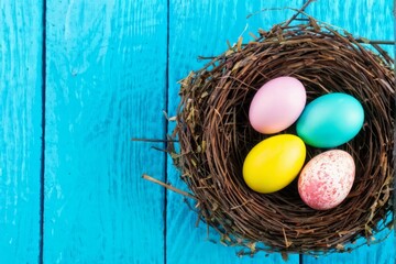 Obraz premium Colorful Easter Eggs Nestled in a Bird's Nest on a Blue Wooden Background