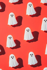 Cute white ghosts pattern on bright color background