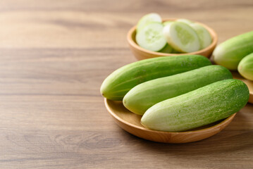 Fresh cucumber on wooden plate, Organic vegetable, Food ingredient
