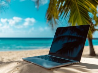 Laptop on a sandy beach with a stunning ocean view, perfect for remote work or digital nomad lifestyle.