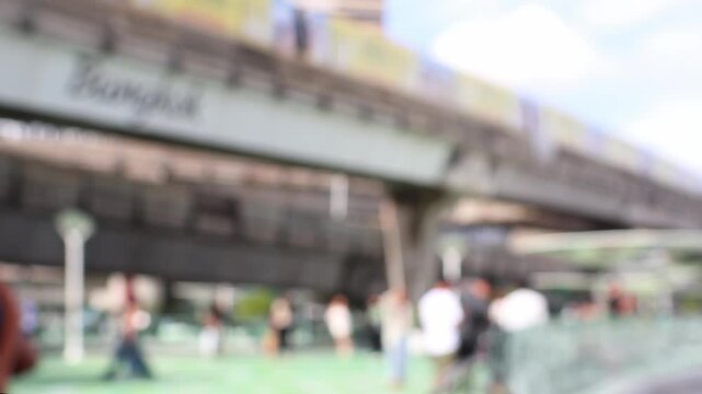 Blurred view of tourists taking pictures at Skywalk near MBK mall, Siam square mall, sky train, Bangkok, Thailand.