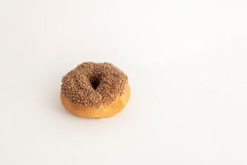 donut with sprinkles on a light background, sweet pastries, donut day, fat thursday
