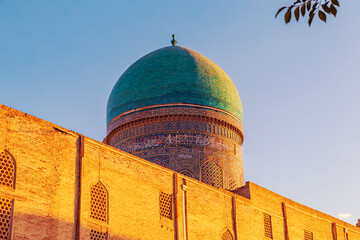 The ancient Mir-i-Arab madrasah at sunset.