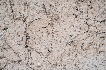 The texture of dirt and straw used for a primitive building structure.