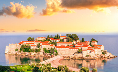 Fototapeta premium panoramic landscape of sea island sunrise or sunset with beautiful orange roofs and buildings, sea gulf water and scrnic colorful morning cloudy sky on background