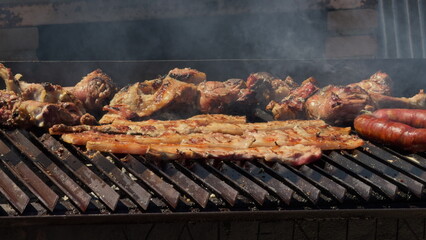 Assorted Meats Grilling Over a Smoky Barbecue