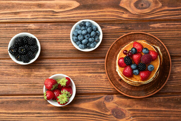 Stack of homemade american pancakes with berries . Top view