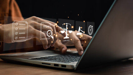 Compliance in business concept. Laws concept. Enforce laws, regulations and standards, comply with business policies, Businessman use laptop with compliance icon on virtual screen.