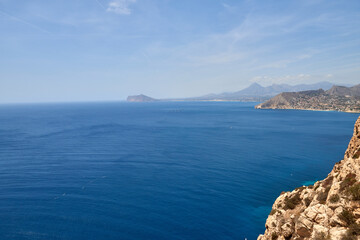 Obraz premium Breathtaking Panoramic Mountain View: Majestic Sea, Dramatic Sky, and Rugged Cliff Edge Overlooking Coastal Horizon. Awe-Inspiring Coastal Landscape: Stunning Aerial Perspective of Ocean, Cloudscape