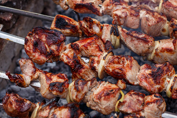 Pork shashlik is cooked on the grill
