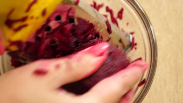Table beets are rubbed on a grater. Preparation of beetroot dishes.