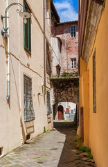 Lucca beautiful medieval historical center alley with ancient arch