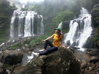 hikers backpacks standing on top of a mountain and enjoying nature view