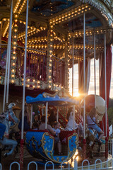 carousel at sunset, colorful amusement park. city festival