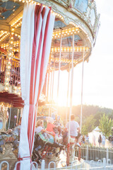 carousel at sunset, colorful amusement park. city festival © alipko