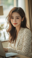 Asian woman working on her laptop from her home office, reflecting the work-from-home lifestyle and a balanced approach to modern life