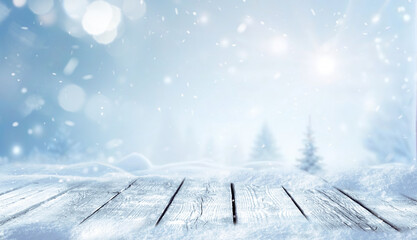 Winter christmas scenic landscape with wooden flooring strewn with snow in forest  in background blurred fir-trees covered with snow on nature.