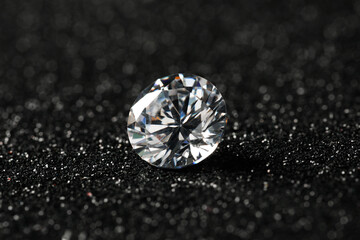 Beautiful dazzling diamond on dark shiny background, closeup