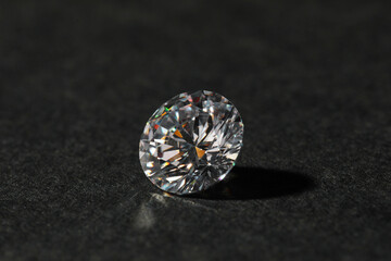 Beautiful shiny diamond on black table, closeup