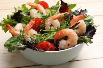 Delicious shrimp salad with vegetables on wooden table, closeup