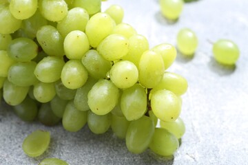 Fresh ripe grapes on grey table, closeup