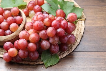 Fresh ripe grapes on wooden table, closeup