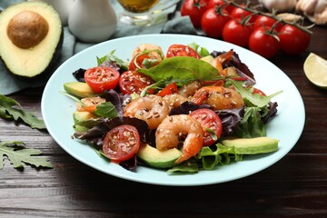 Delicious shrimp salad and ingredients on wooden table, closeup