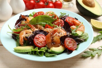 Delicious shrimp salad and ingredients on white wooden table, closeup