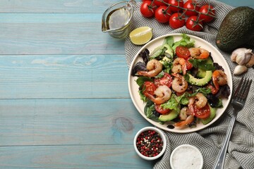 Delicious shrimp salad and ingredients on light blue wooden table, flat lay. Space for text