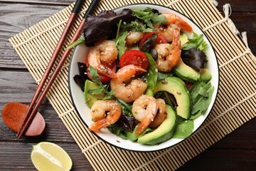 Delicious shrimp salad on wooden table, flat lay
