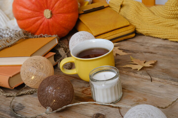 autumn Yellow Leaves, pumpkin, tea coffee in mug on table, concept of outdoor tea party, cozy...