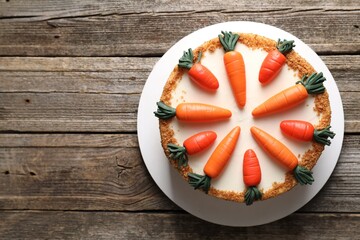 Delicious carrot cake on wooden table, top view. Space for text