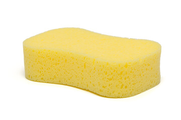 A sponge is bright yellow and isolated on a white background. The surface texture appears porous and is commonly used for cleaning or washing.