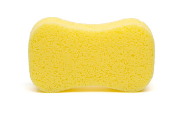 A sponge is bright yellow and isolated on a white background. The surface texture appears porous and is commonly used for cleaning or washing.