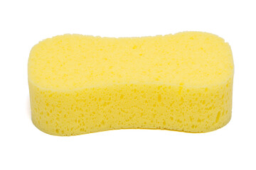 A sponge is bright yellow and isolated on a white background. The surface texture appears porous and is commonly used for cleaning or washing