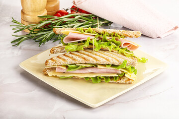 Homemade club sandwich with ham and cheese