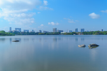 Fototapeta premium City park lake scenery with blue sky and white clouds