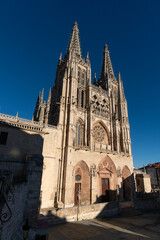 Fototapeta premium Gothic cathedral facade of the city of Burgos at sunset in a suuny day. Castilla y Leon, Spain.