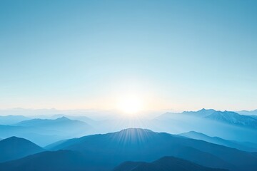Obraz premium A serene landscape showcasing mountains under a clear blue sky with the sun rising in the background, creating a tranquil atmosphere.