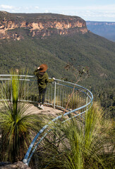 Girl on lookout with brown hat looking at beautiful valley of Blue mountains, NSW, Australia. © Oleg Podzorov