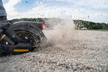 Riding scooter on a gravel road