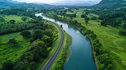 Obraz premium quiet country road that follows the edge of a serene river.