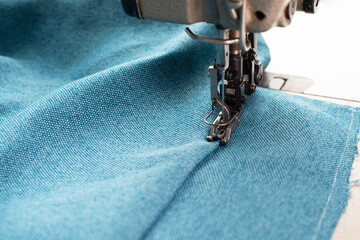 Industrial sewing machine with blue fabric, working place, manufacture for clothes, handmade, small...